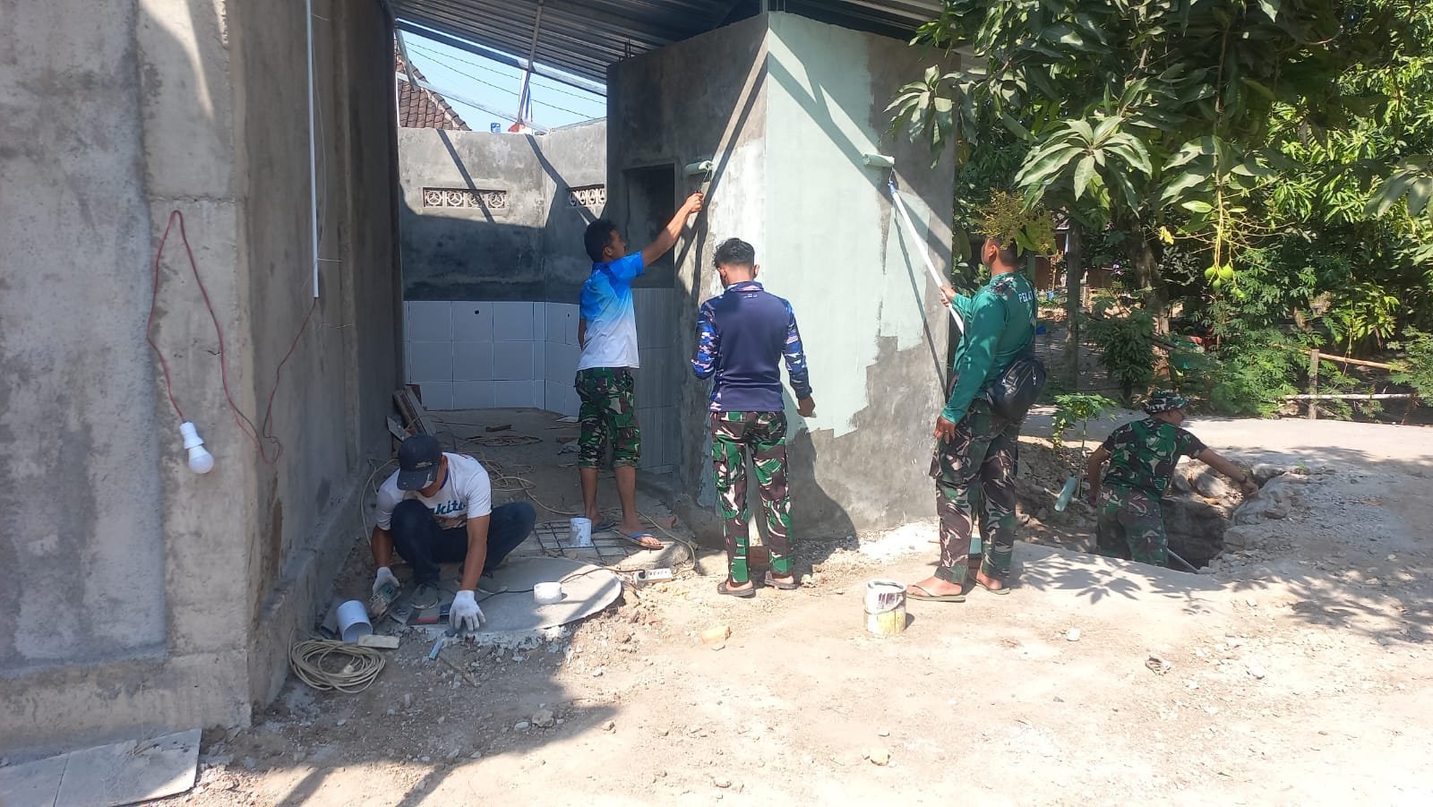 Satgas TMMD Bersama Warga Rapikan Pengecatan Tempat Wudhu Masjid Al Mubarok