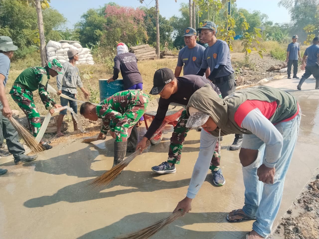 Sentuhan Akhir Jalan Parangjoro: Warga dan Prajurit Bersihkan Beton Basah
